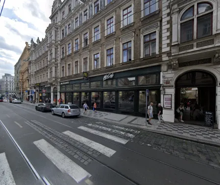 Pick-up point at Vodičkova 15 in Prague: city street with tram tracks and a McDonald's with McCafé on the ground floor